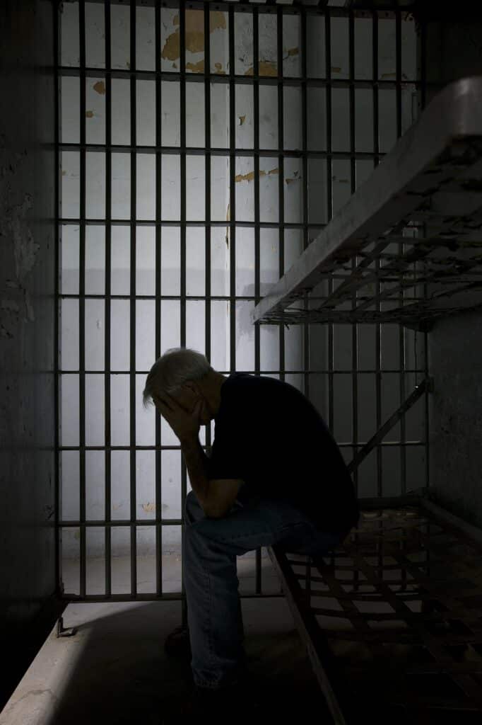 Prisoner in Old Jail Cell | Criminal Defense Law Firm | Law Offices of Clifton Black