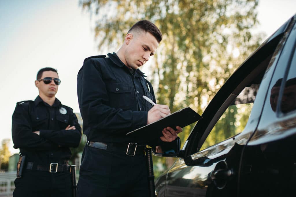 Police Officers Checking Vehicles | DUI Lawyer Colorado Springs​​ | Law Offices of Clifton Black