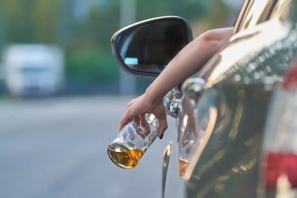 Driver Holding Bottle of Alcohol | DUI Lawyer Colorado Springs​​ | Law Offices of Clifton Black