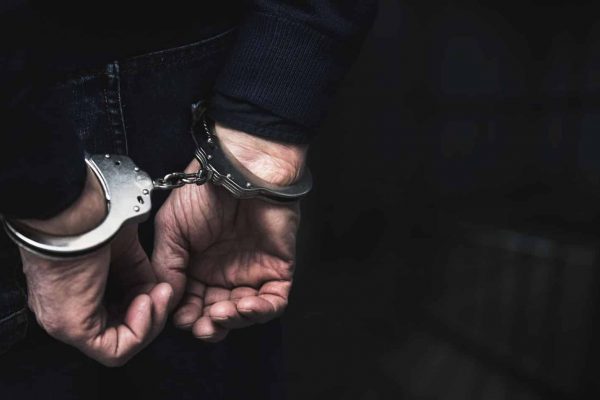 Man in Handcuffs for Committing Sex Crimes | Sex Crime Attorney | Law Offices of Clifton Black